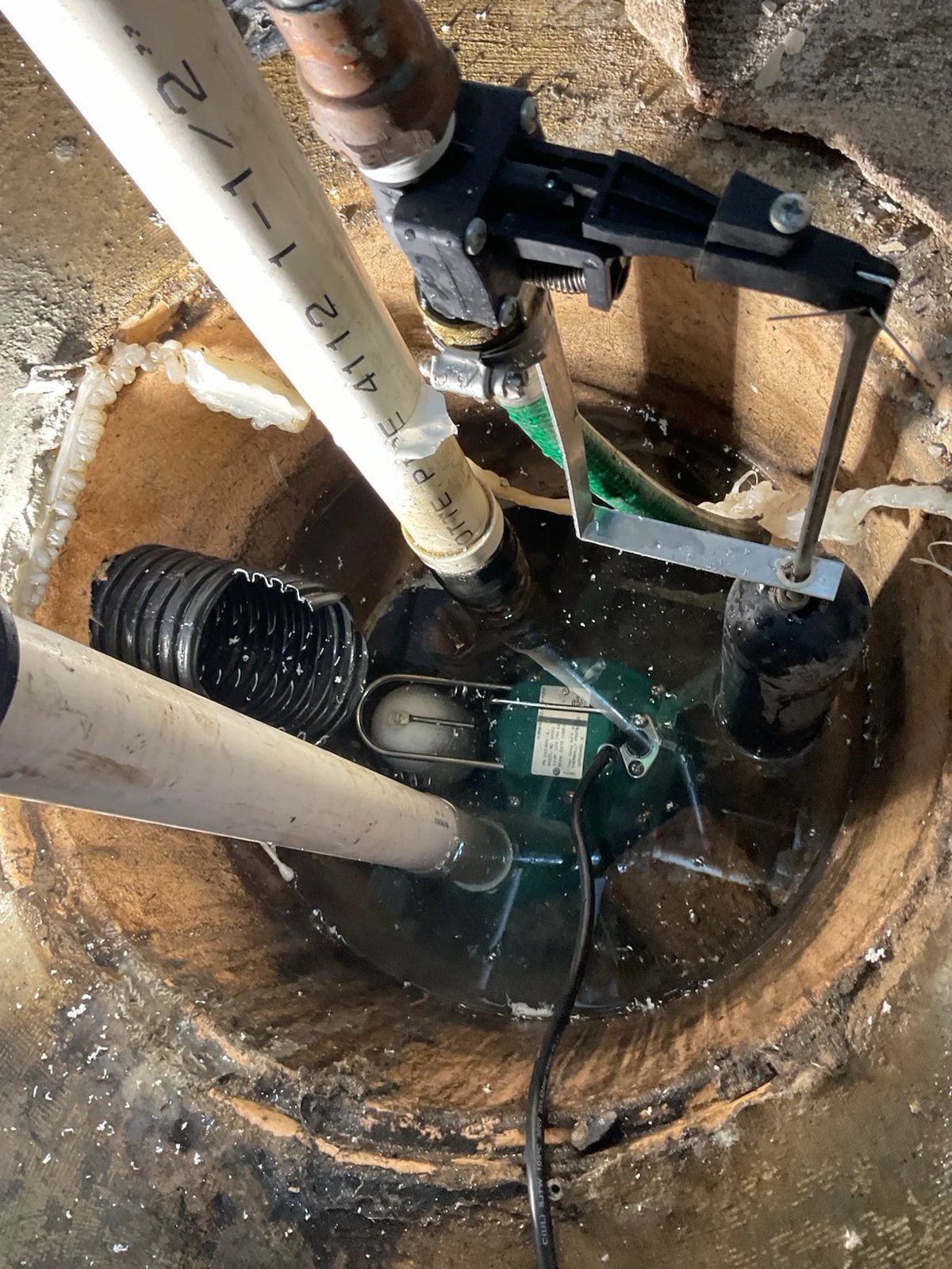 Replacement sump pump in the pit with new discharge pipe