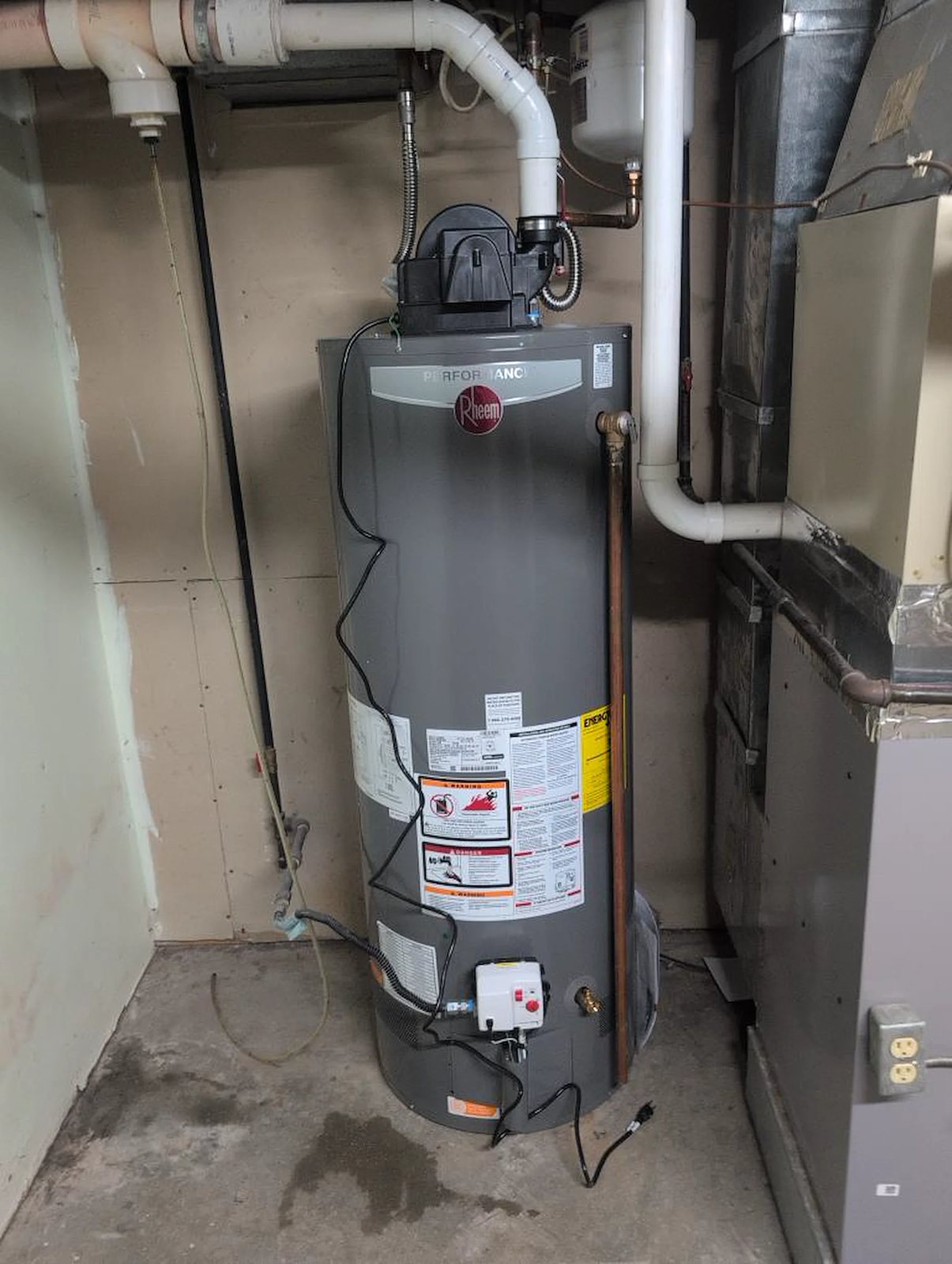 Power-vent gas water heater installed in a basement
